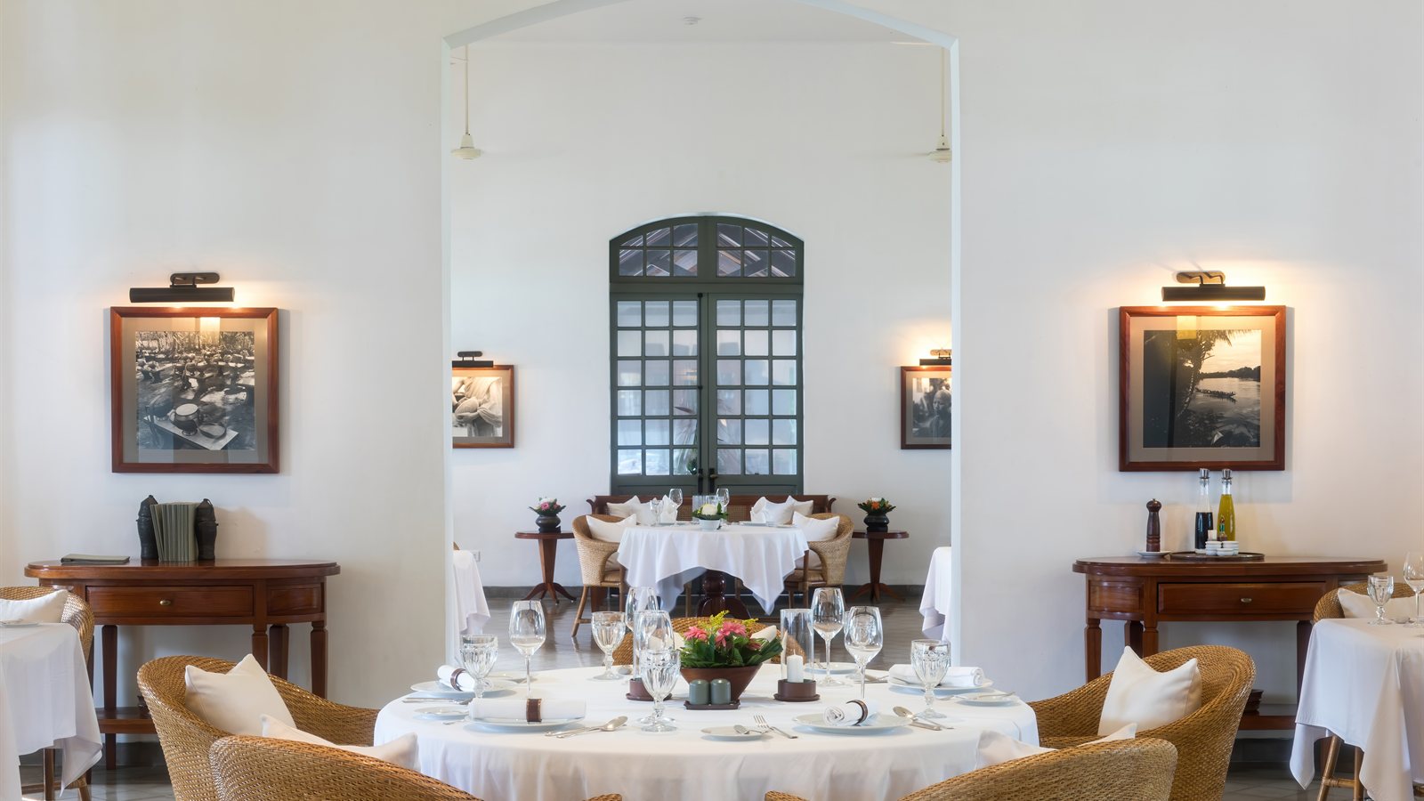 Table laid for breakfast with white linen and glassware